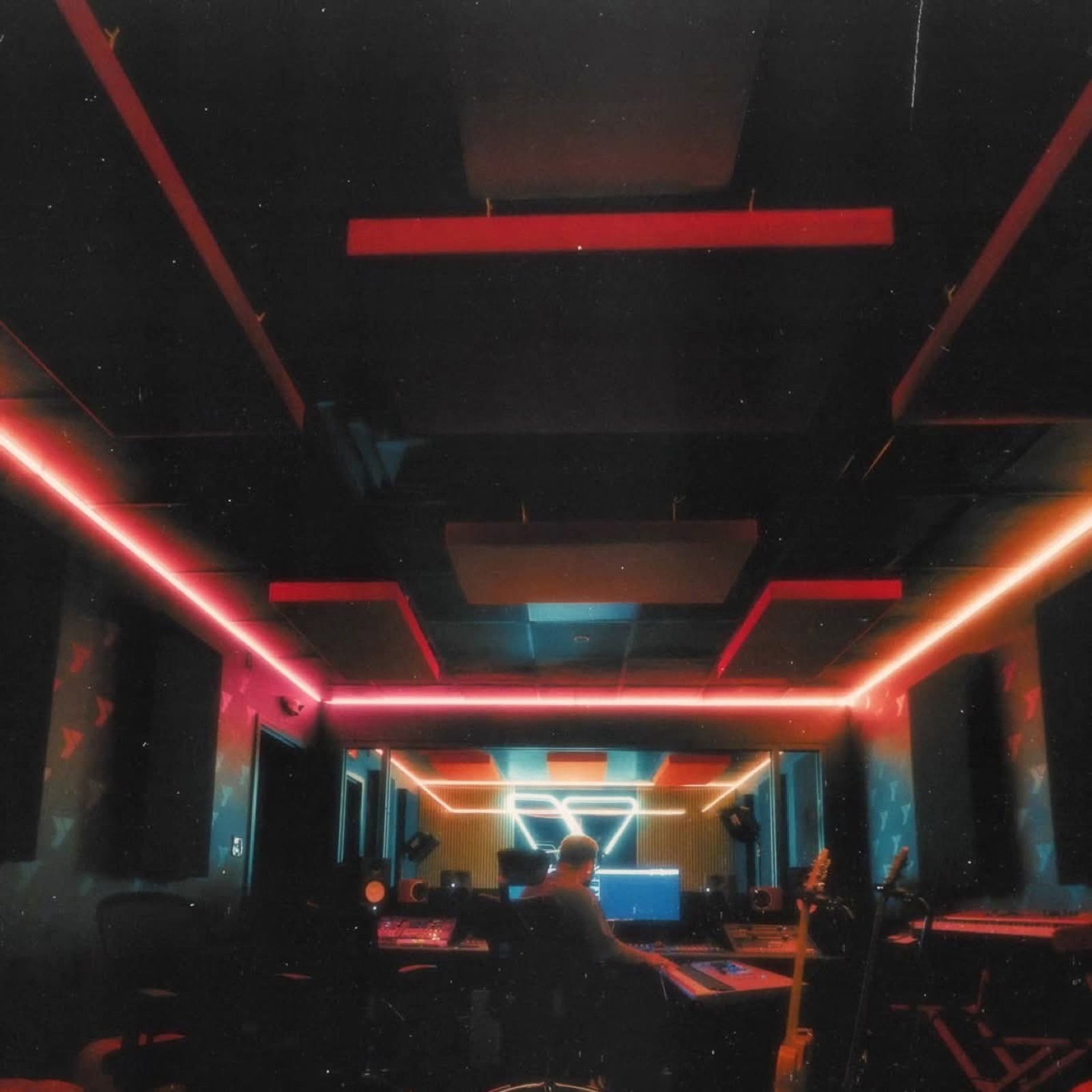 Recording studio room with neon lights and instruments